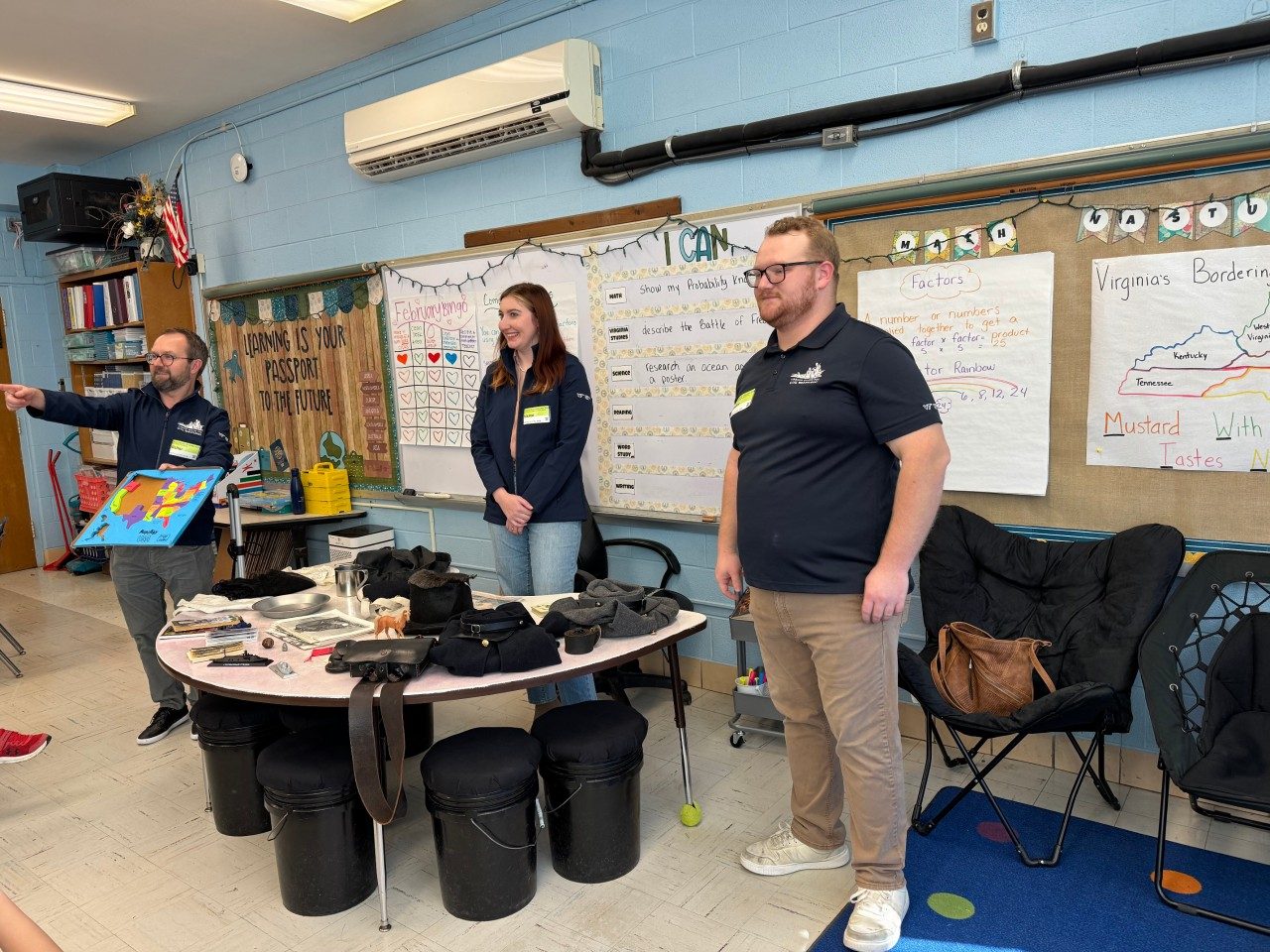 Three VCCWS staffers speak to a fourth-grade classrooms
